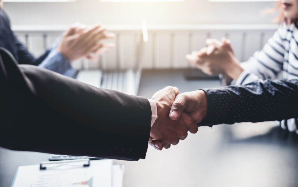 Business success. Business people shaking hands in the meeting. Negotiating business.