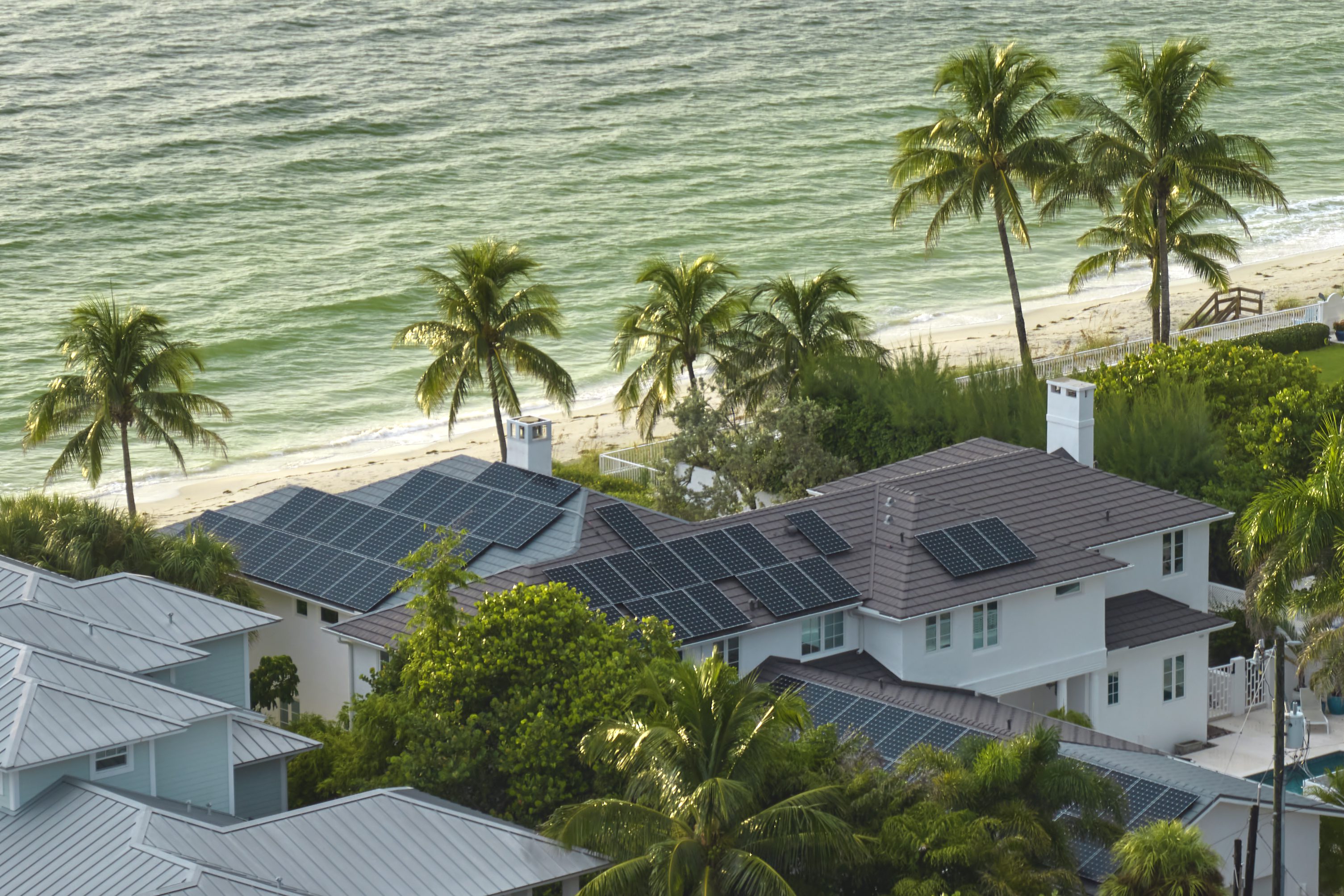 Aerial view of expensive american building roof with blue solar photovoltaic panels