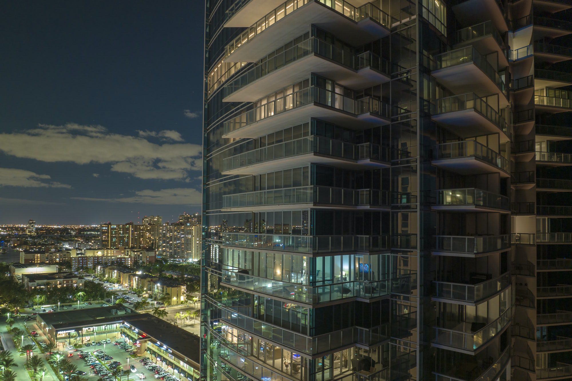 Aerial view of residential high-rise skyscraper at night in Sunny Isles Beach city in Florida